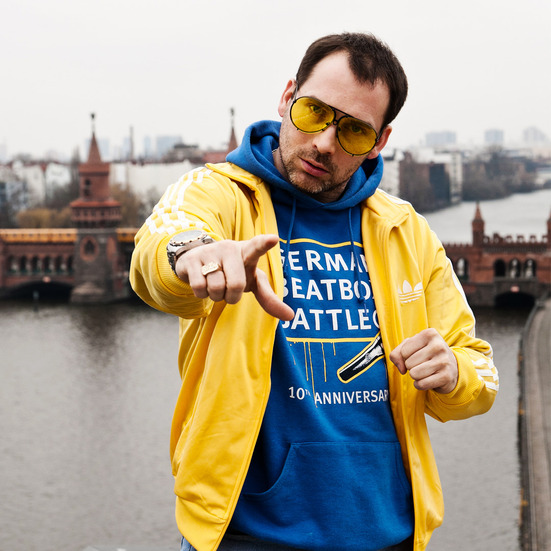 Bee Low the founder of the German Beatbox Battle Championship is standing on the rooftop of the Universal Records building in Berlin-Kreuzberg with the Oberbaumbrücke in the horizon
