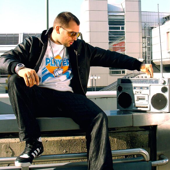 Bee Low the Oldschool B-Boy is listing to Rap Music next to the Messe-Berlin beside the Funkturm in Charlottenburg