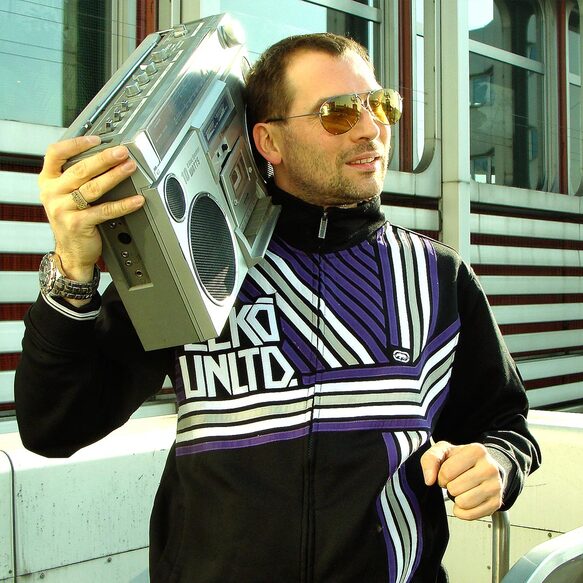 Bee Low the oldschool Hip Hop Pioneer carries a 1980's Tape Recorder Boombox on his shoulder next to the ICC Expo center in Berlin-Charlottenburg