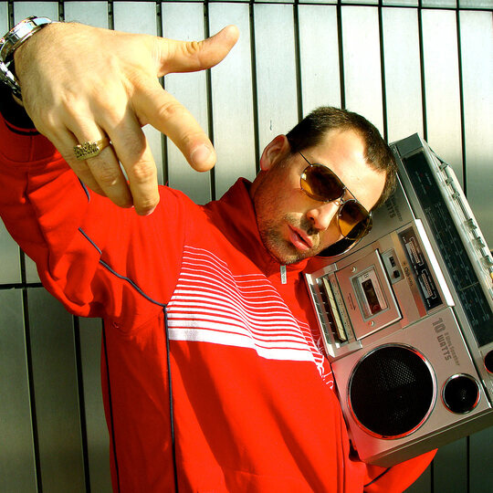 Bee Low the oldschool Hip Hop Pioneer carries a 1980's Tape Recorder Boombox on his shoulder next to the ICC Expo center in Berlin-Charlottenburg