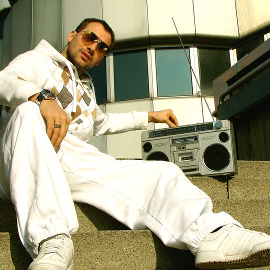 Bee Low the oldschool Hip Hop B-Boy check the frequence of his 1980's Tape Recorder next to the ICC Expo center in Berlin-Charlottenburg