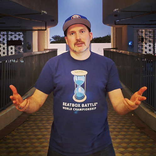 Bee Low the founder and producer of the Beatbox Battle World Championship festival series is posing in car port in Dubai