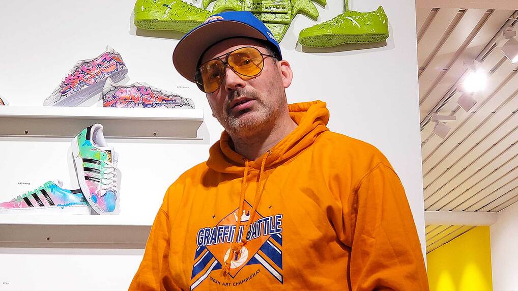 Bee Low the urban artist is standing next to his relief sculpture at the Gallery Affenfaust in Hamburg-Altona