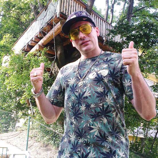 Bee Low is chilling in a camouflage outfit next to a natural tree house in Graz, Austria